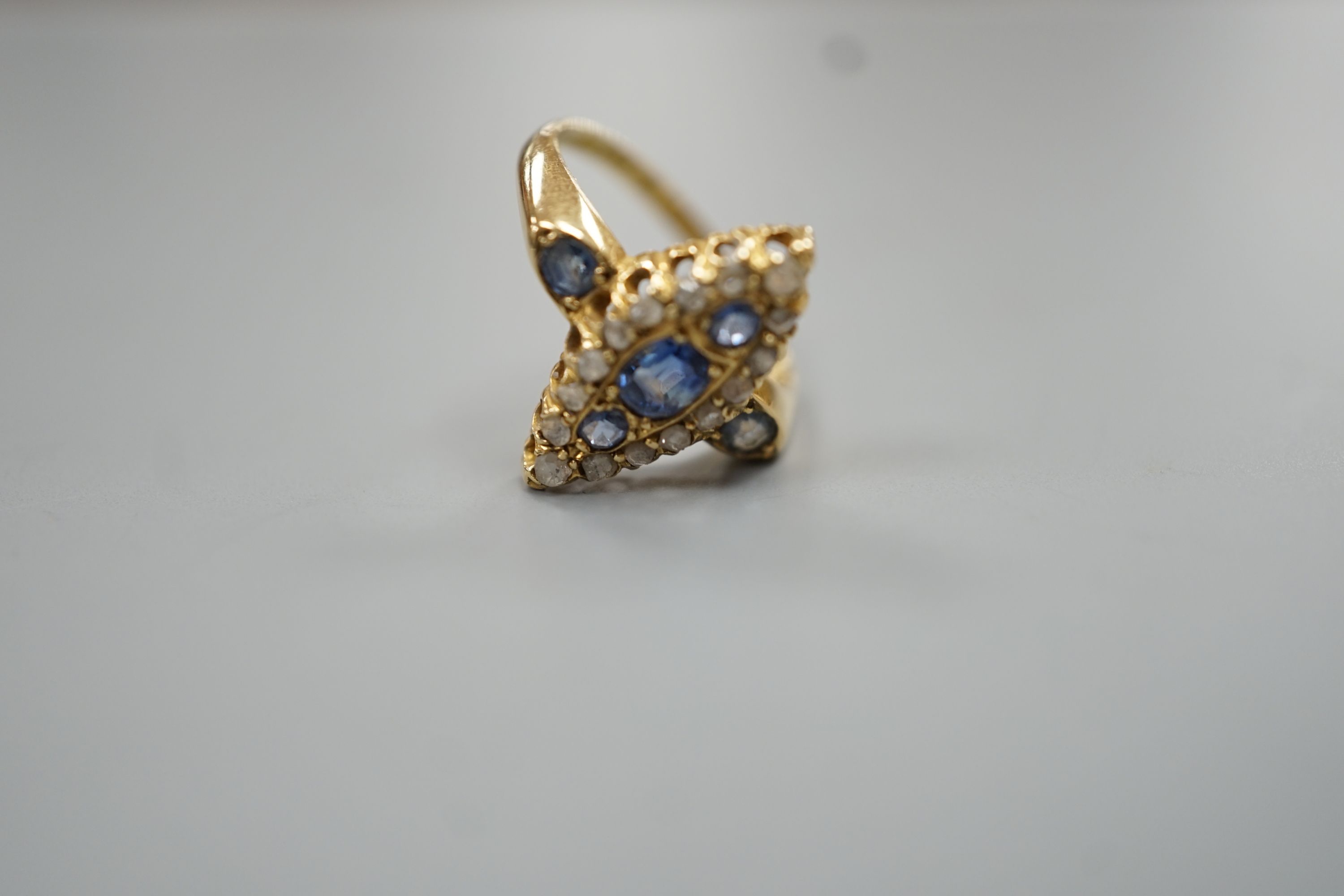 An Edwardian 18ct gold, sapphire and diamond set marquise set cluster ring, size K, gross weight 3.2 grams